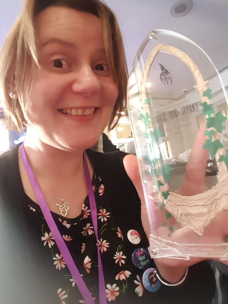 Close-up selfie: Ruth EJ Booth with the British Fantasy Award for Best Non-Fiction 2019